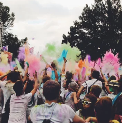 A demo photo of DET "Speak About the Photo" questions: a vibrant outdoor festival.